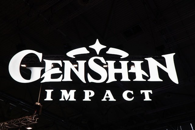 Smartphone showing Genshin Impact mobile gameplay with a character on screen.